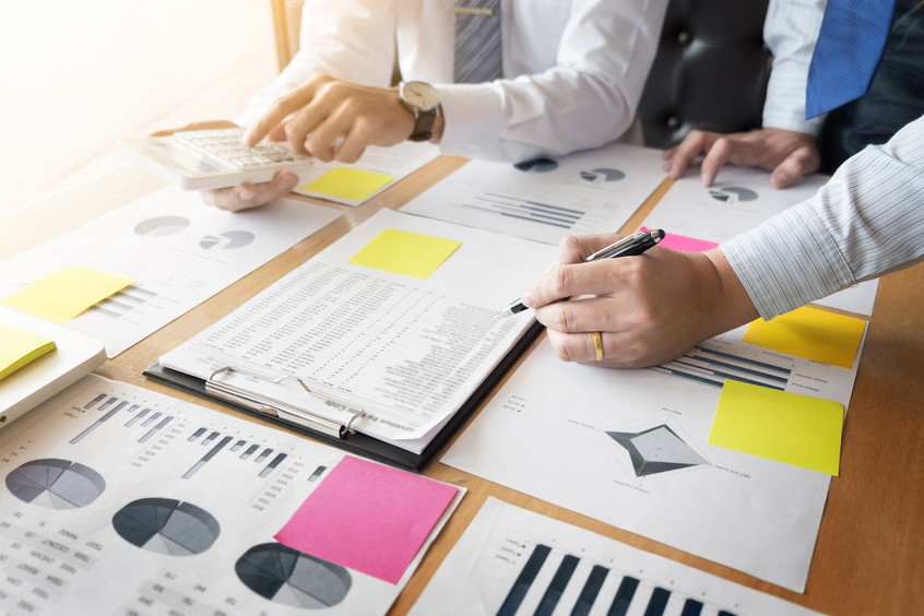 Administrator business man financial inspector and secretary making report, calculating or checking balance. Internal Revenue Service inspector checking document. Audit concept