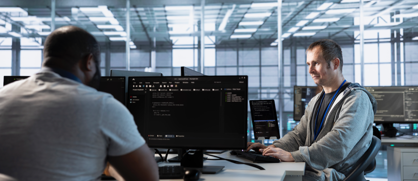 Computer scientists in data center coordinating deployment of server architecture, improving data processing speed. Server farm specialists expert configuring and testing hardware