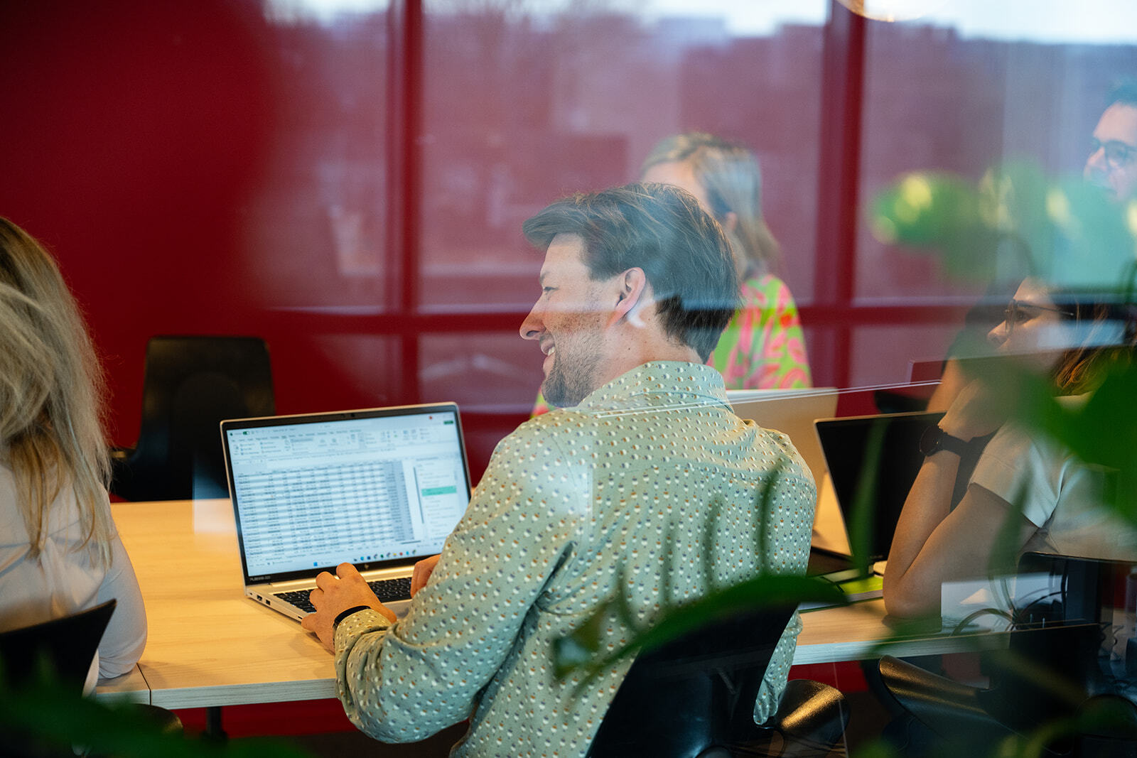 Finance team analyzing data on laptops while evaluating practical AI use cases in finance.