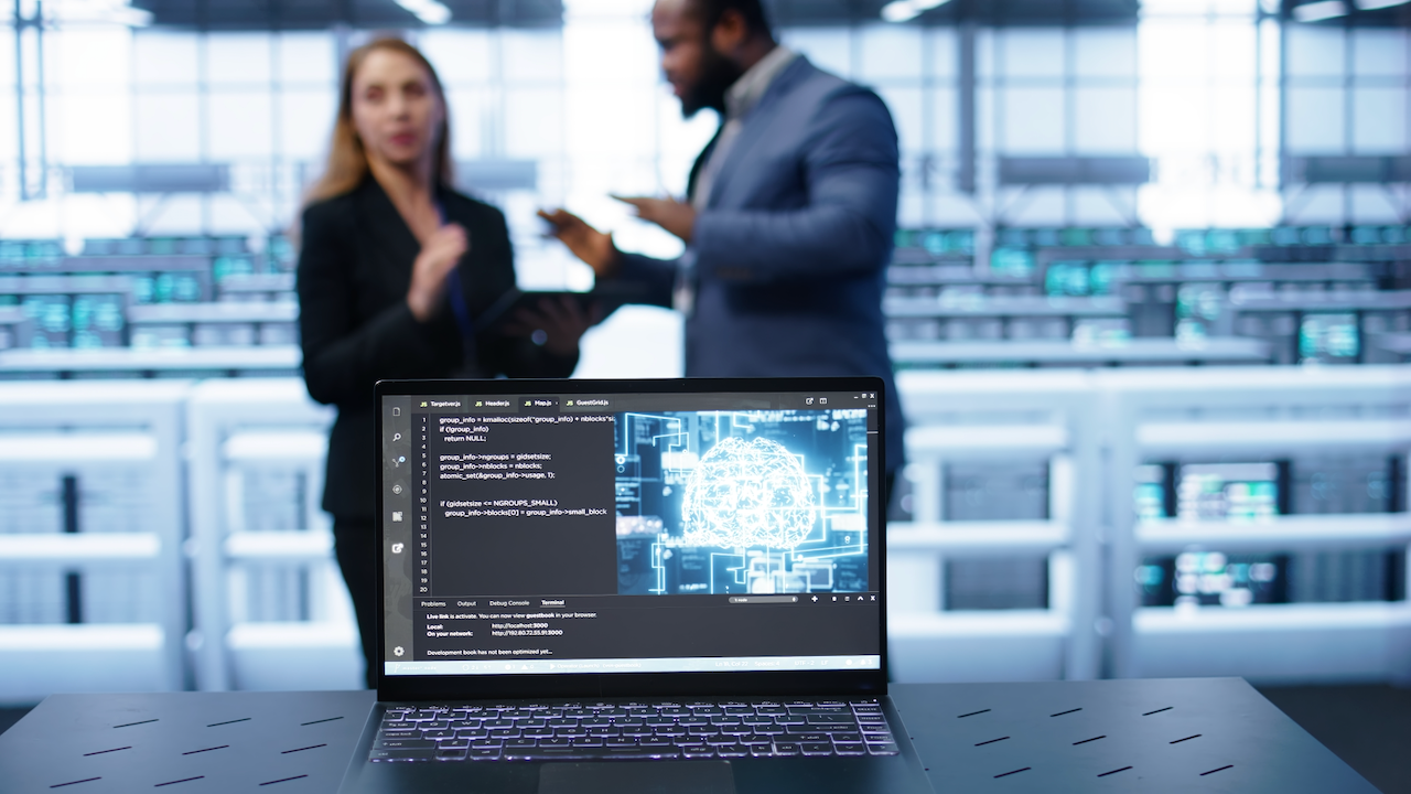 Laptop in data center establishment with artificial intelligence computing simulating human brain. Close up shot of notebook displaying AI machine learning algorithms, camera B